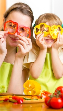 mother and kid preparing healthy food and having fun