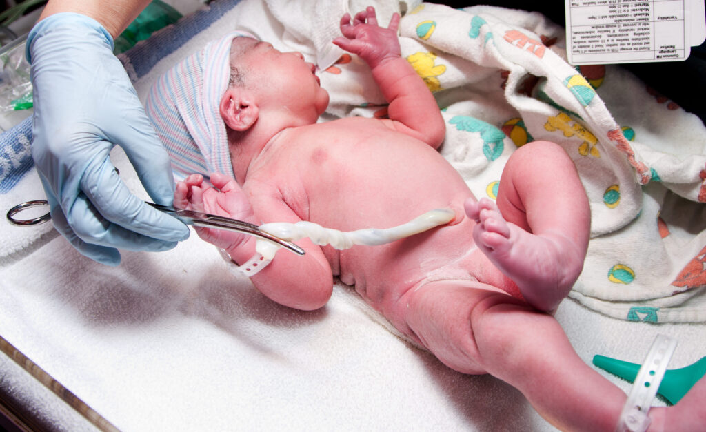 Newborn cute infant baby with umbilical cord